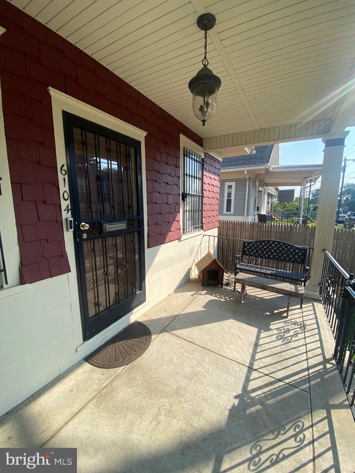 a view of a porch with furniture and floor to ceiling window