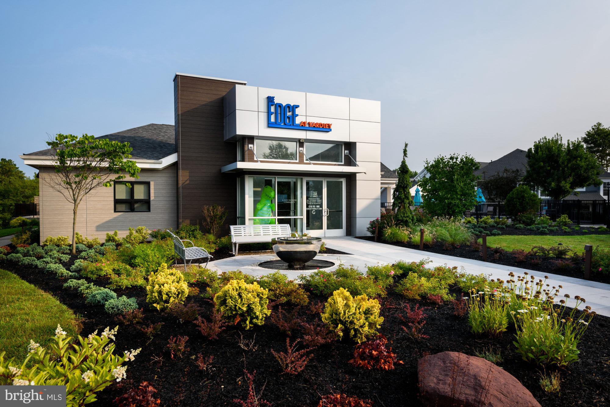 a front view of a house with a yard and outdoor seating