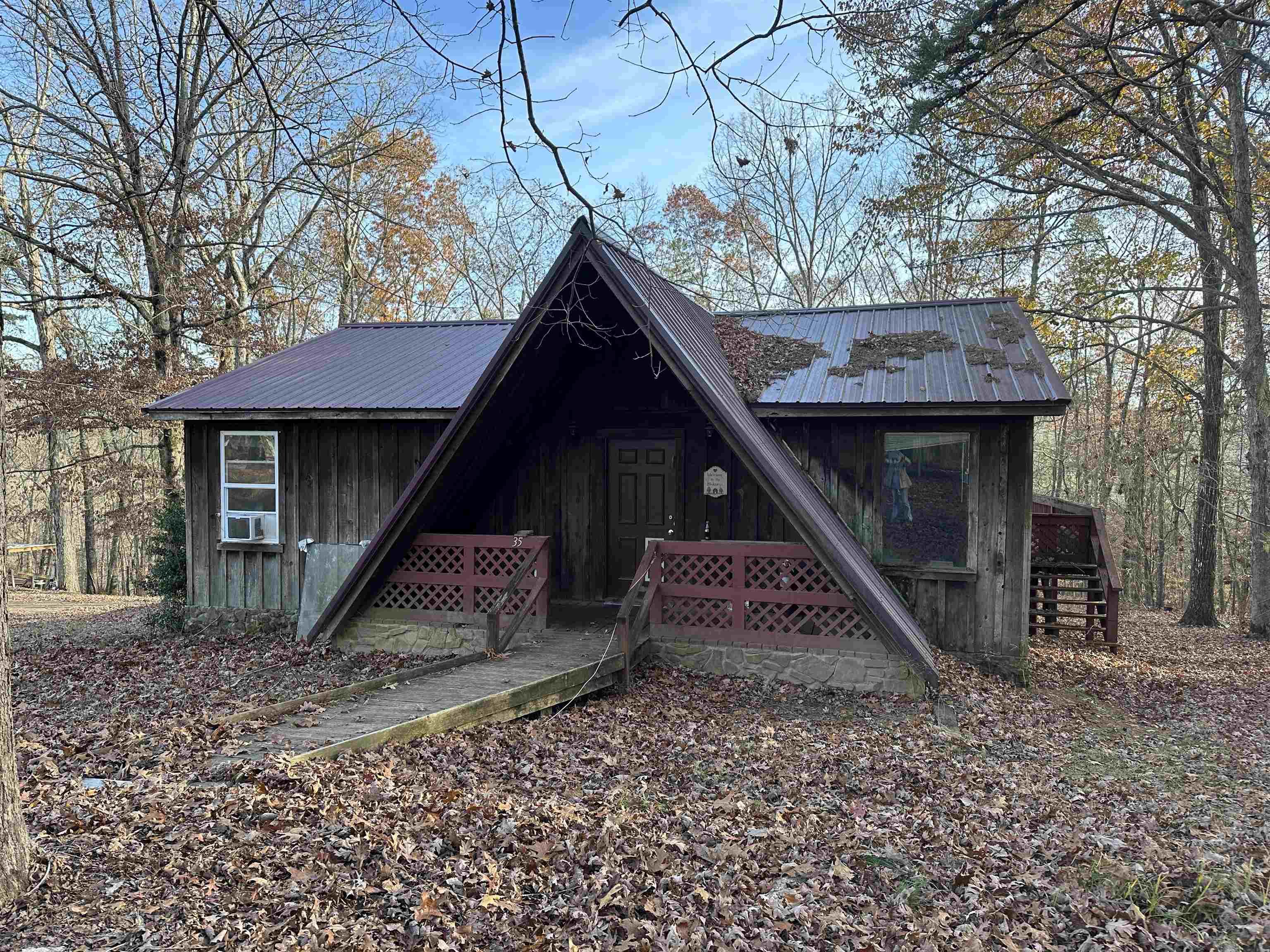 a view of a wooden house with a yard