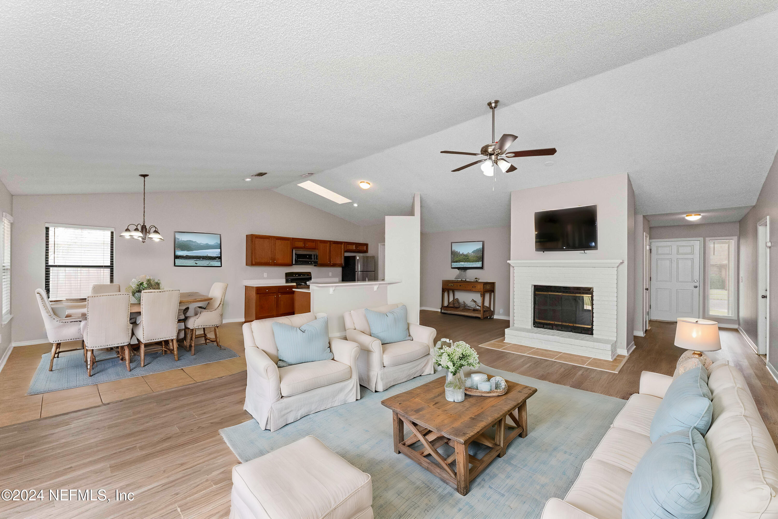 a living room with furniture fireplace and wooden floor