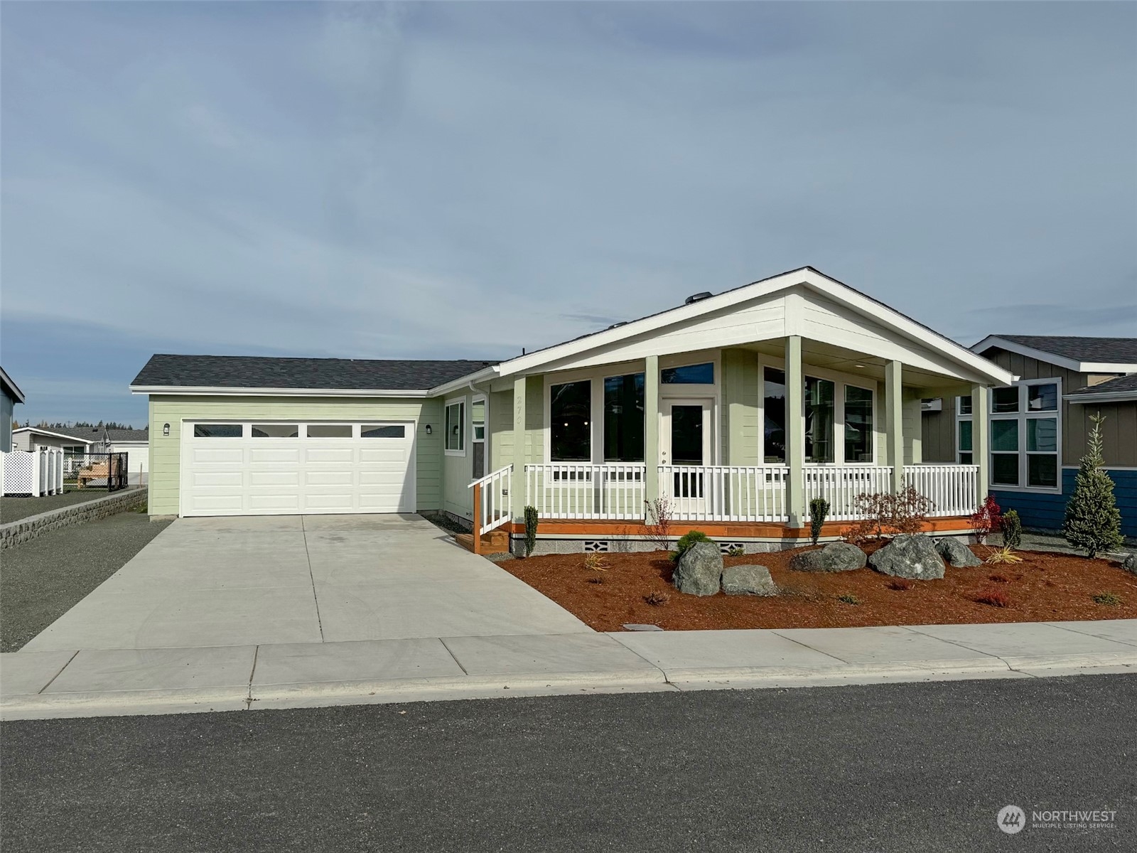 a front view of a house with sitting area