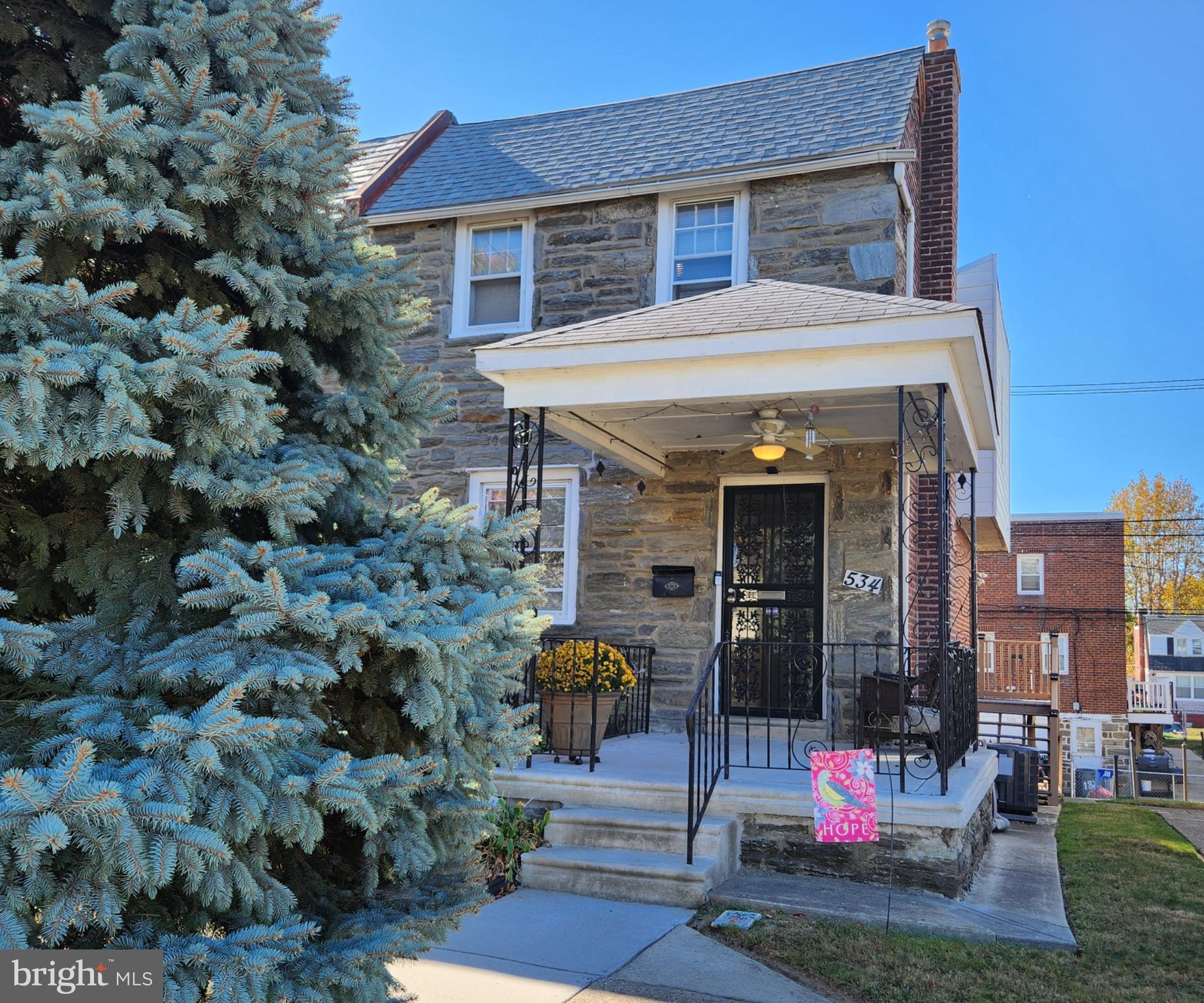 a view of a house with outdoor seating and a yard