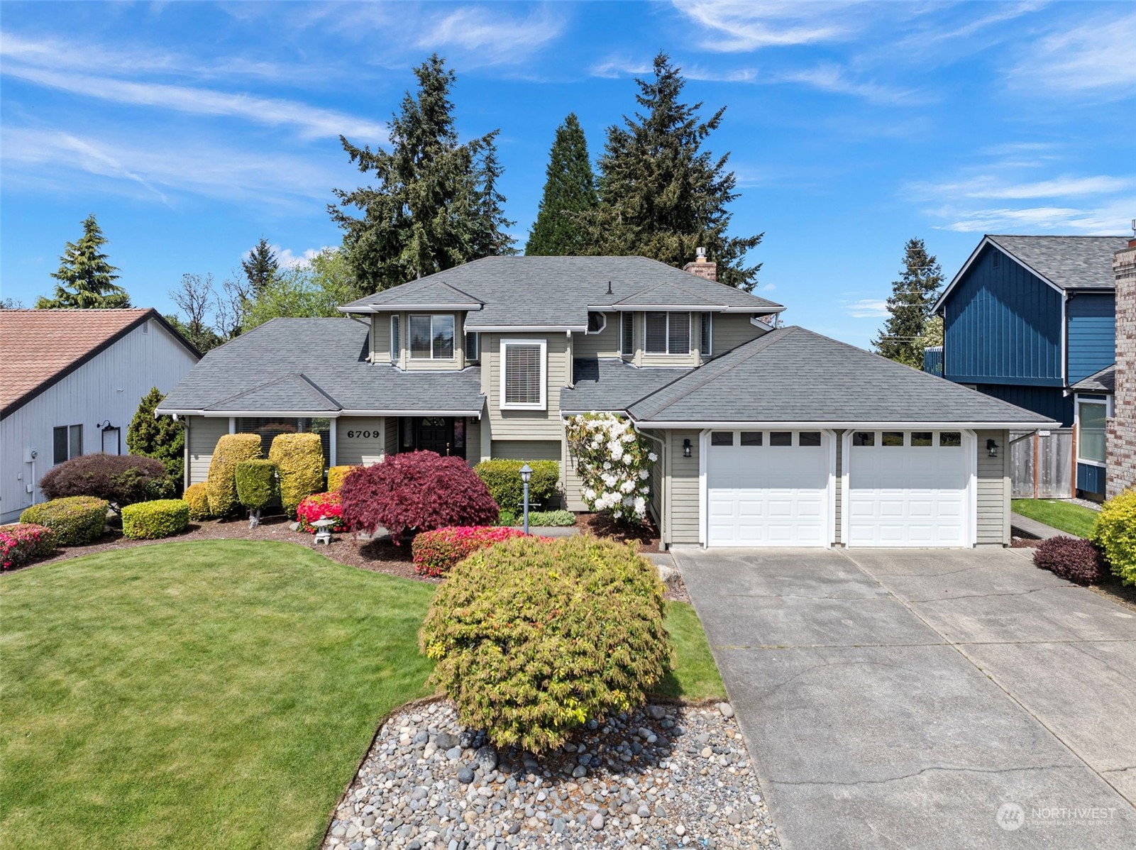 a front view of a house with garden