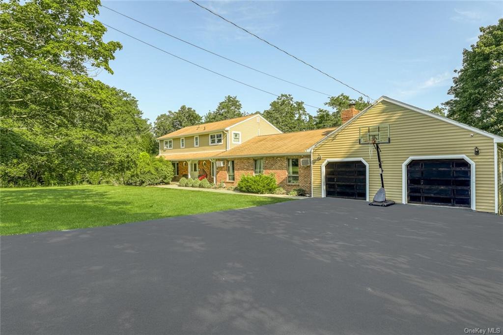 a view of house with outdoor space and parking