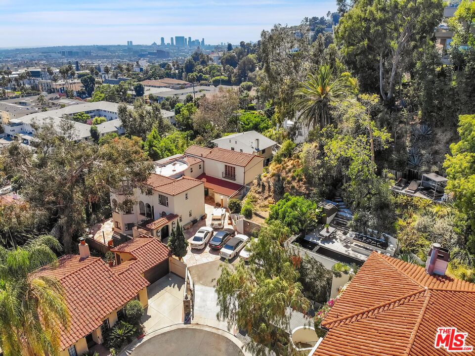 an aerial view of multiple houses with yard