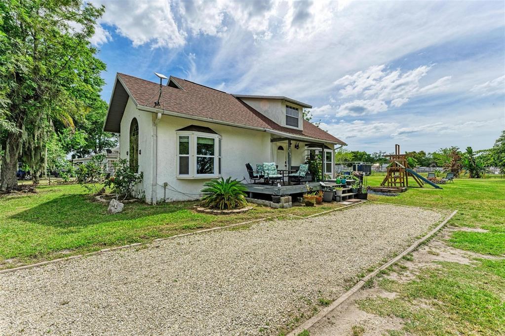 a view of a house with backyard porch and sitting area