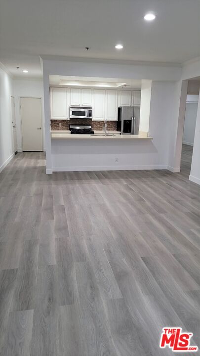 a view of a kitchen with stainless steel appliances