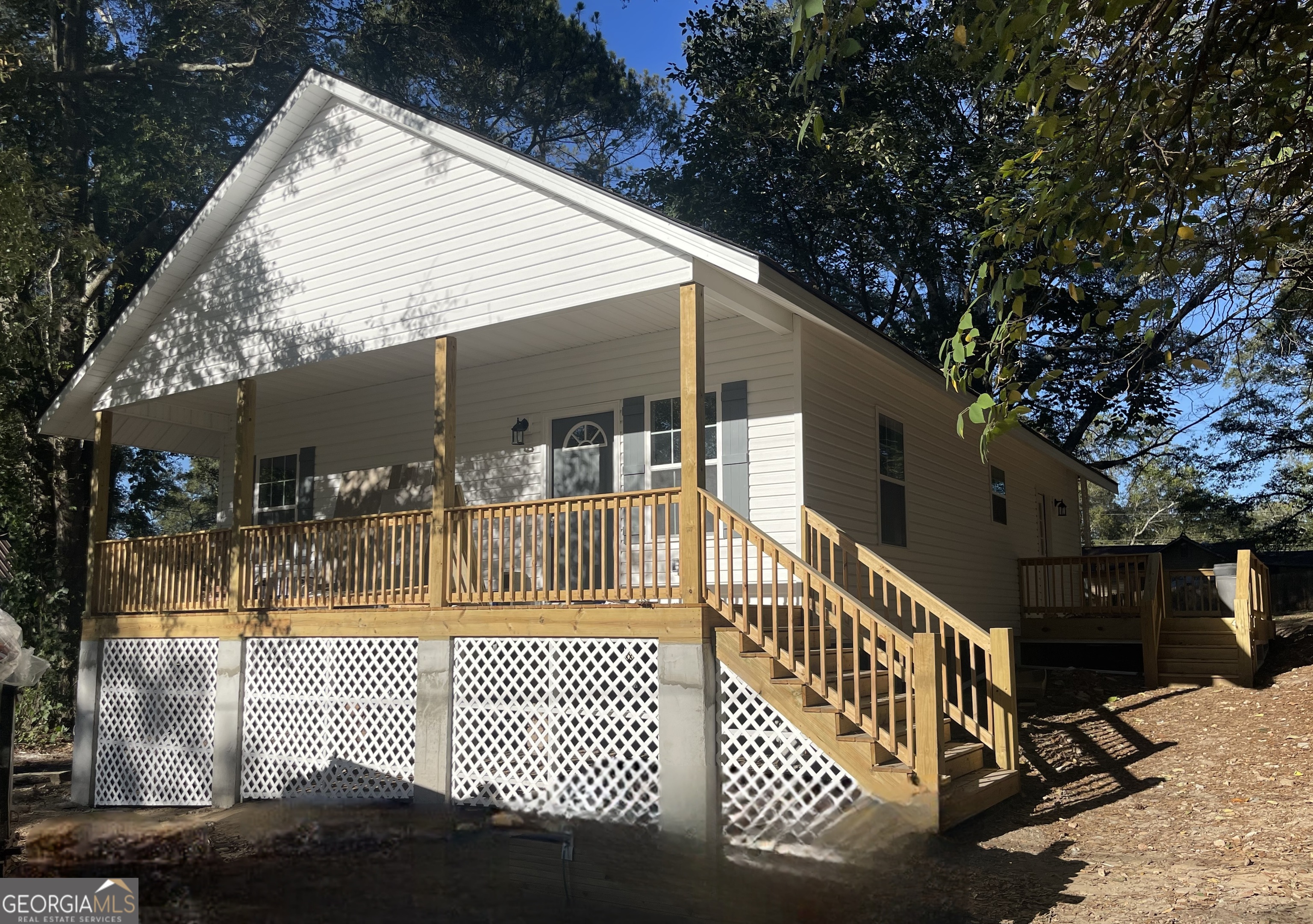 a view of a house with a wooden deck