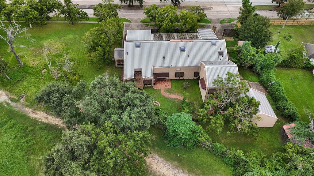 an aerial view of a house with a yard and lake view