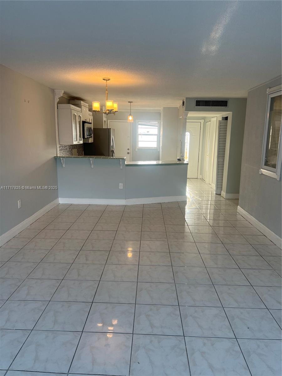 a view of a livingroom with furniture and an entryway