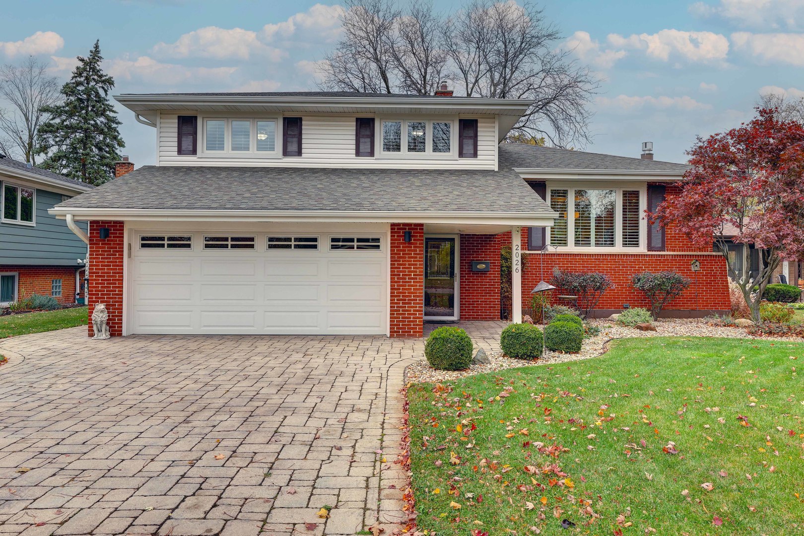 a front view of a house with garden