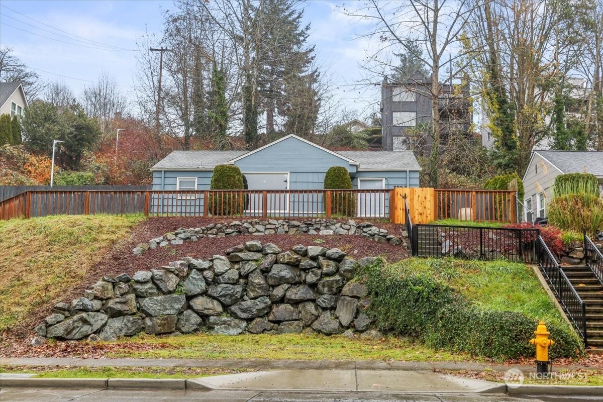 a front view of a house with a garden