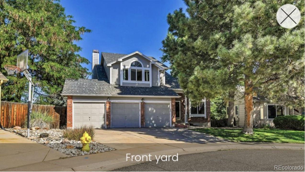 a front view of a house with a garden and garage