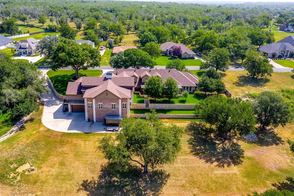 an aerial view of house with yard swimming pool and outdoor seating