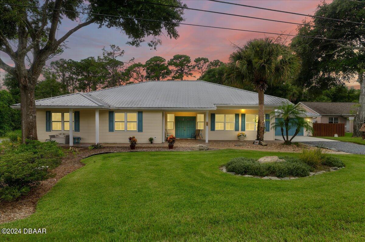 a front view of a house with swimming pool having outdoor seating