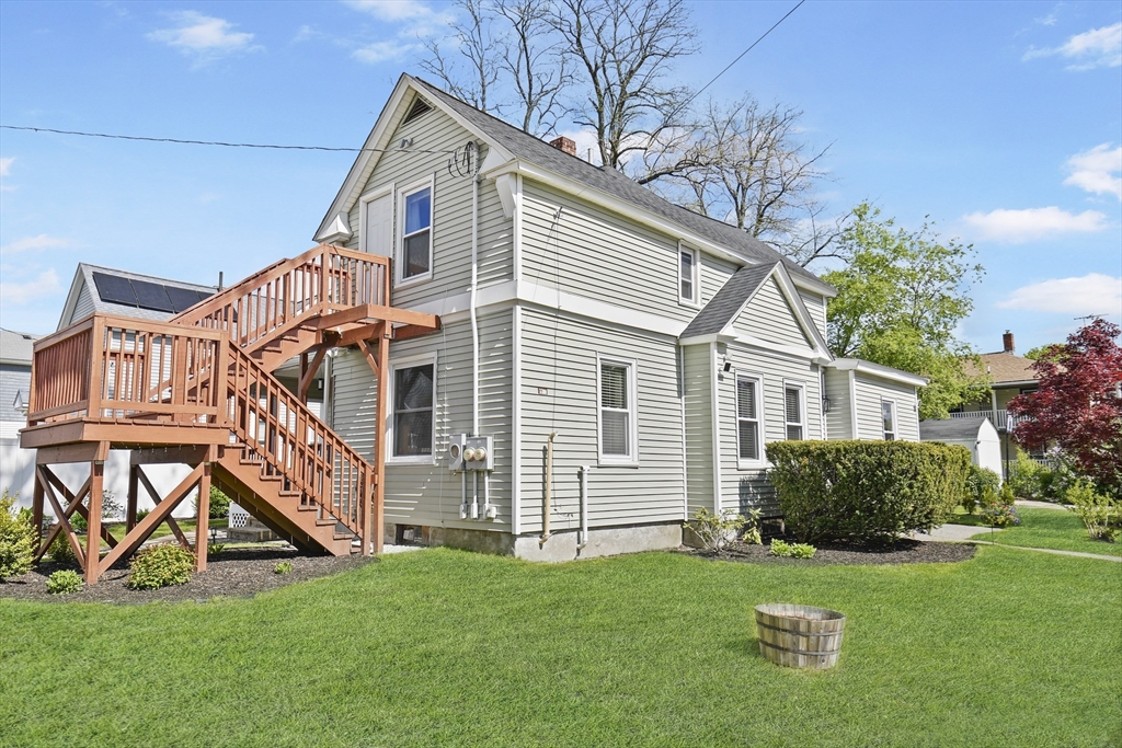 a front view of a house with a yard and trees