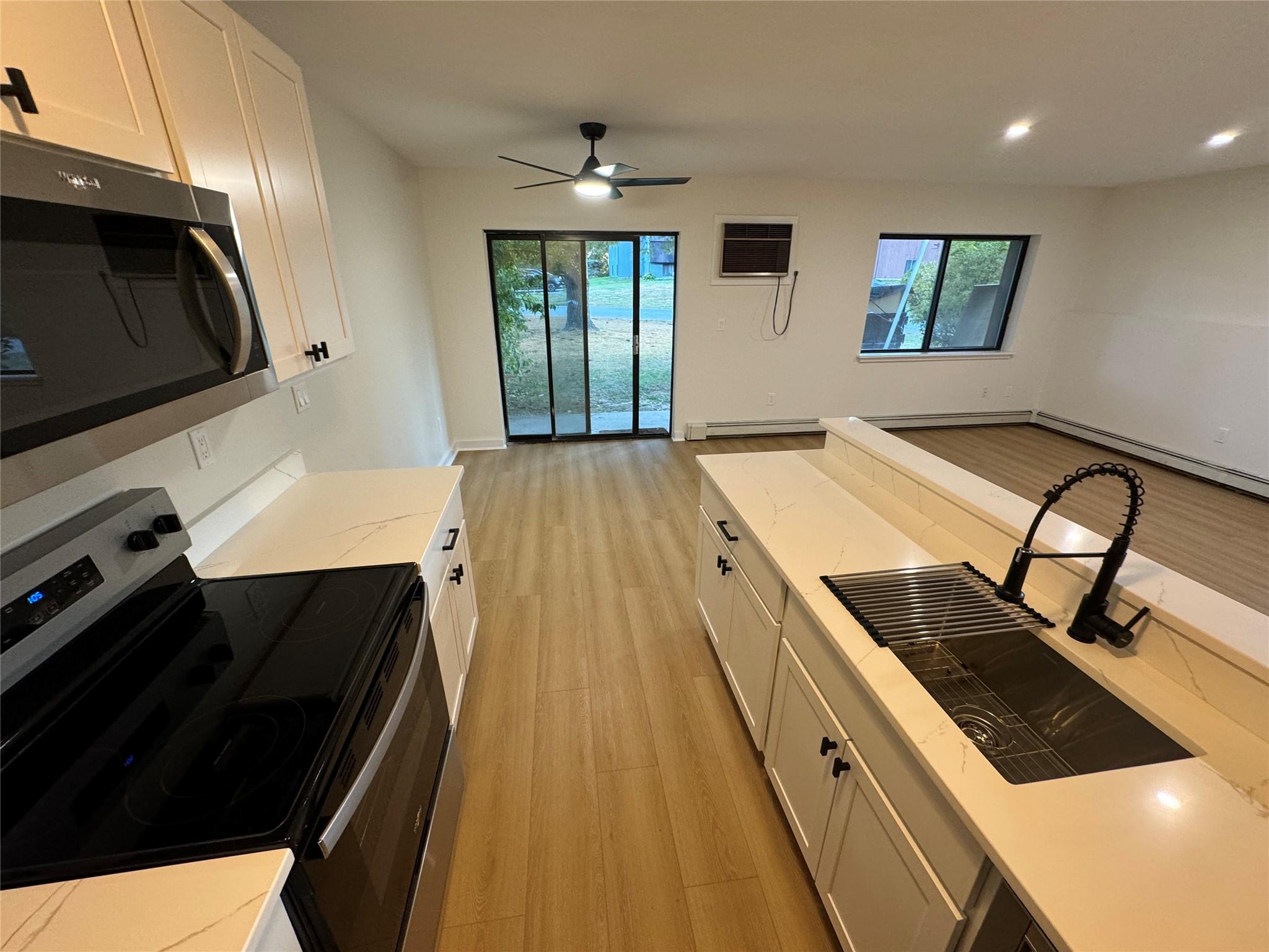 a kitchen with a stove a sink and a microwave