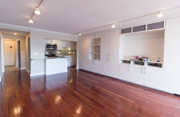 a view of a kitchen with wooden floor and a window