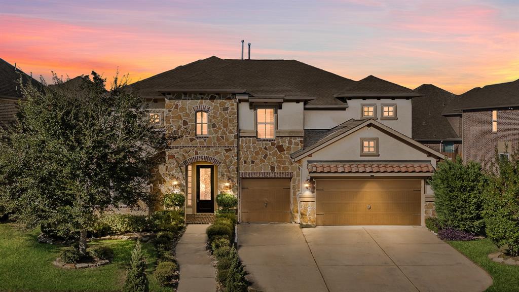 a front view of a house with a yard and garage