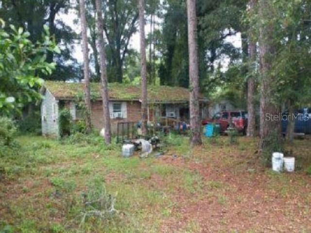 a view of a house with a yard and sitting area