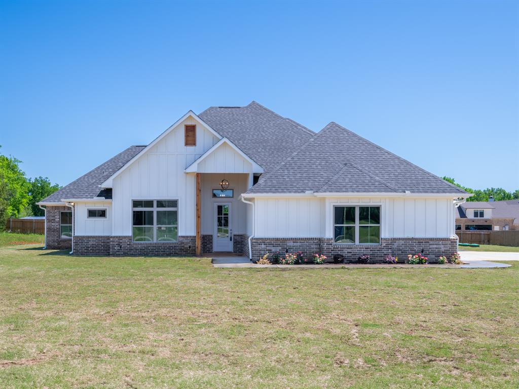 a front view of house with yard and seating area