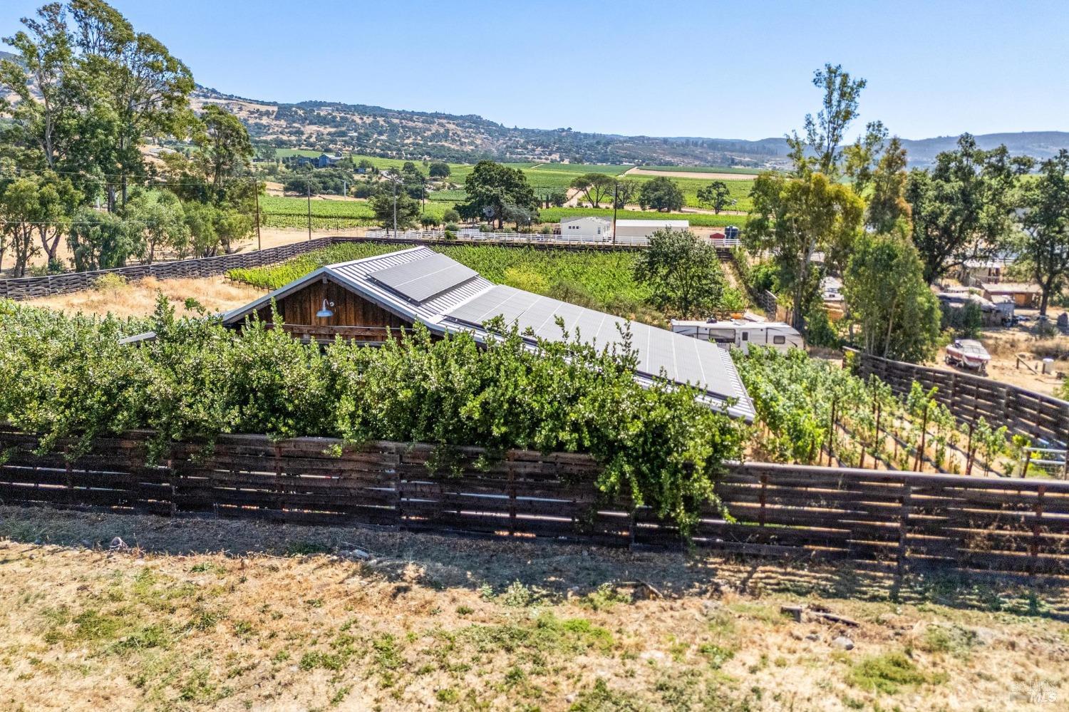 a view of a yard with wooden fence