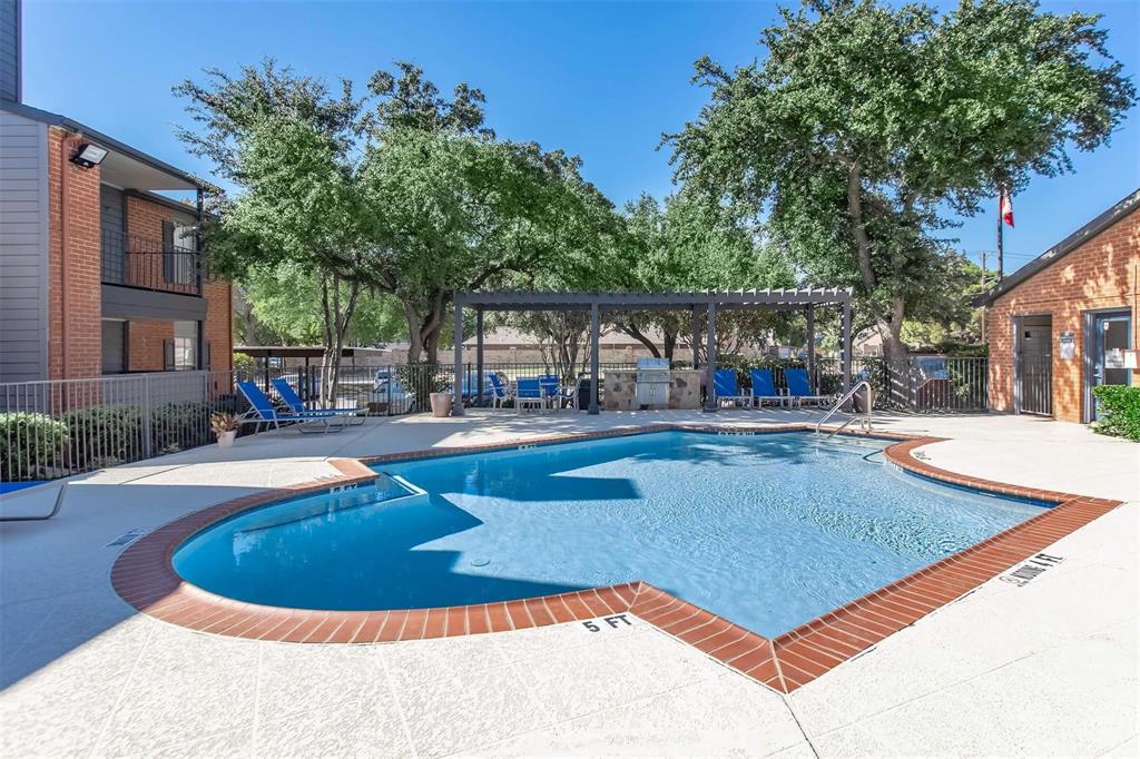 a view of a swimming pool with sitting area