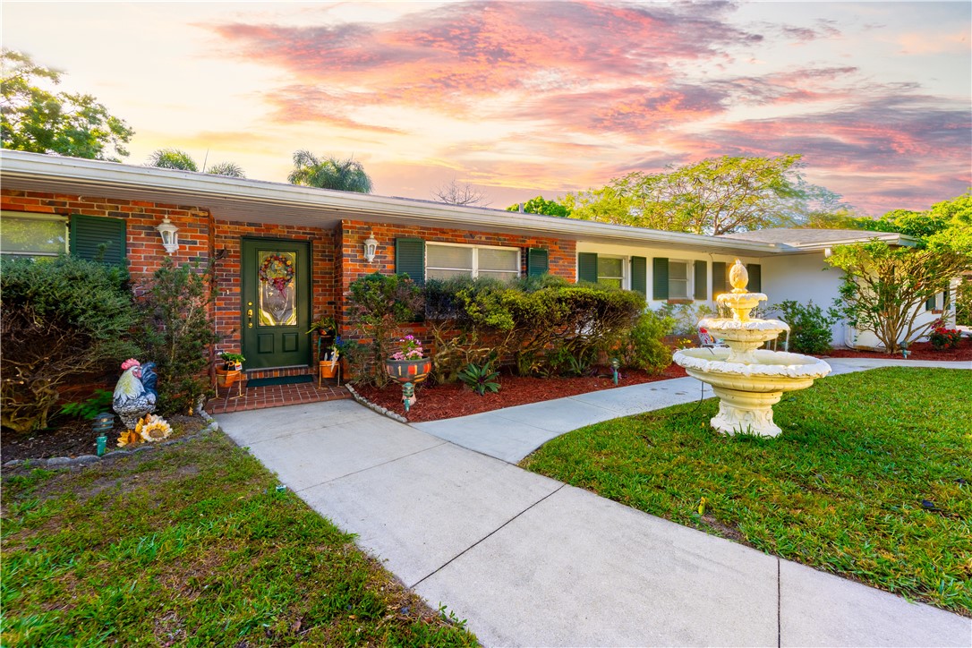 a front view of house with yard having outdoor seating