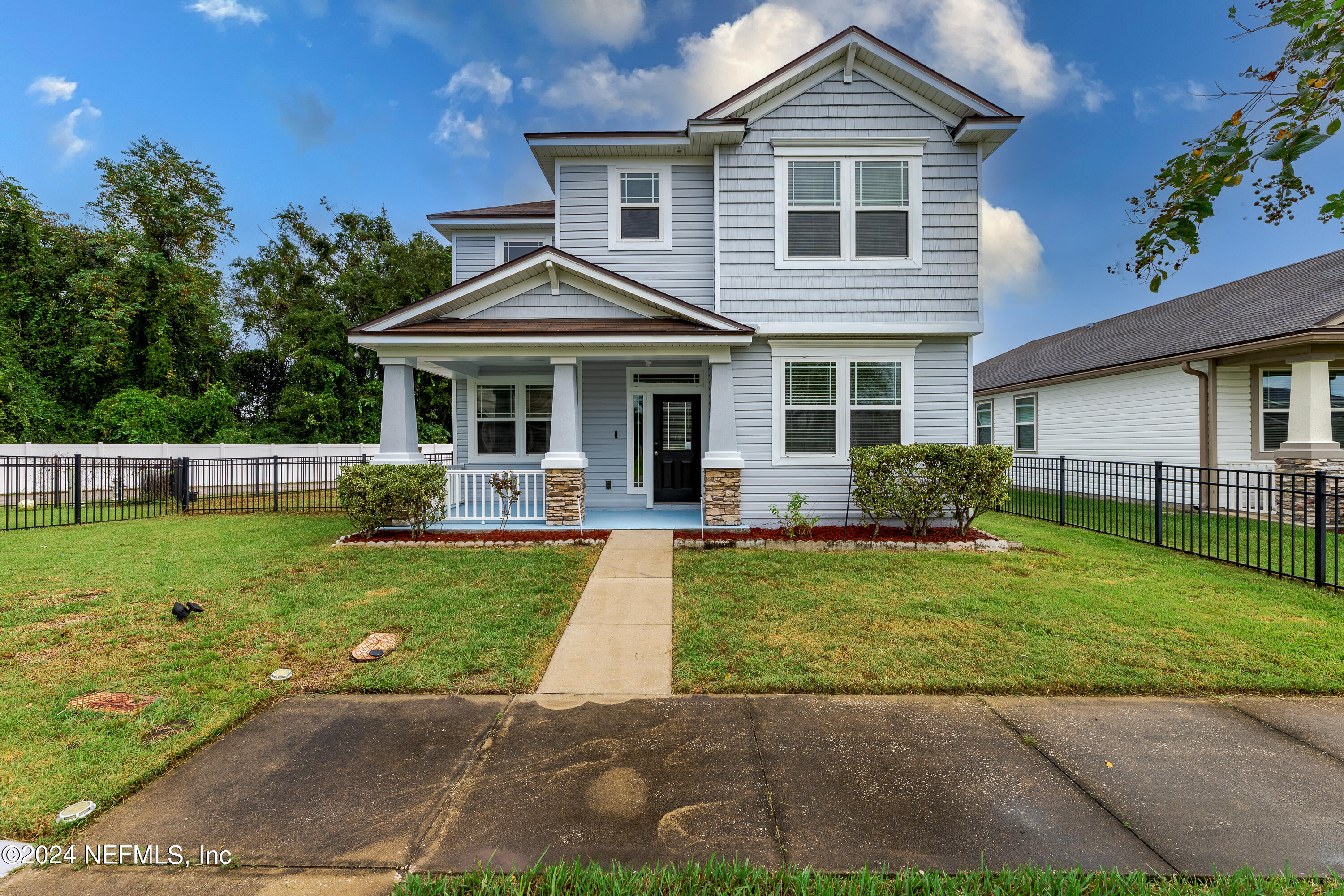 a front view of a house with a garden