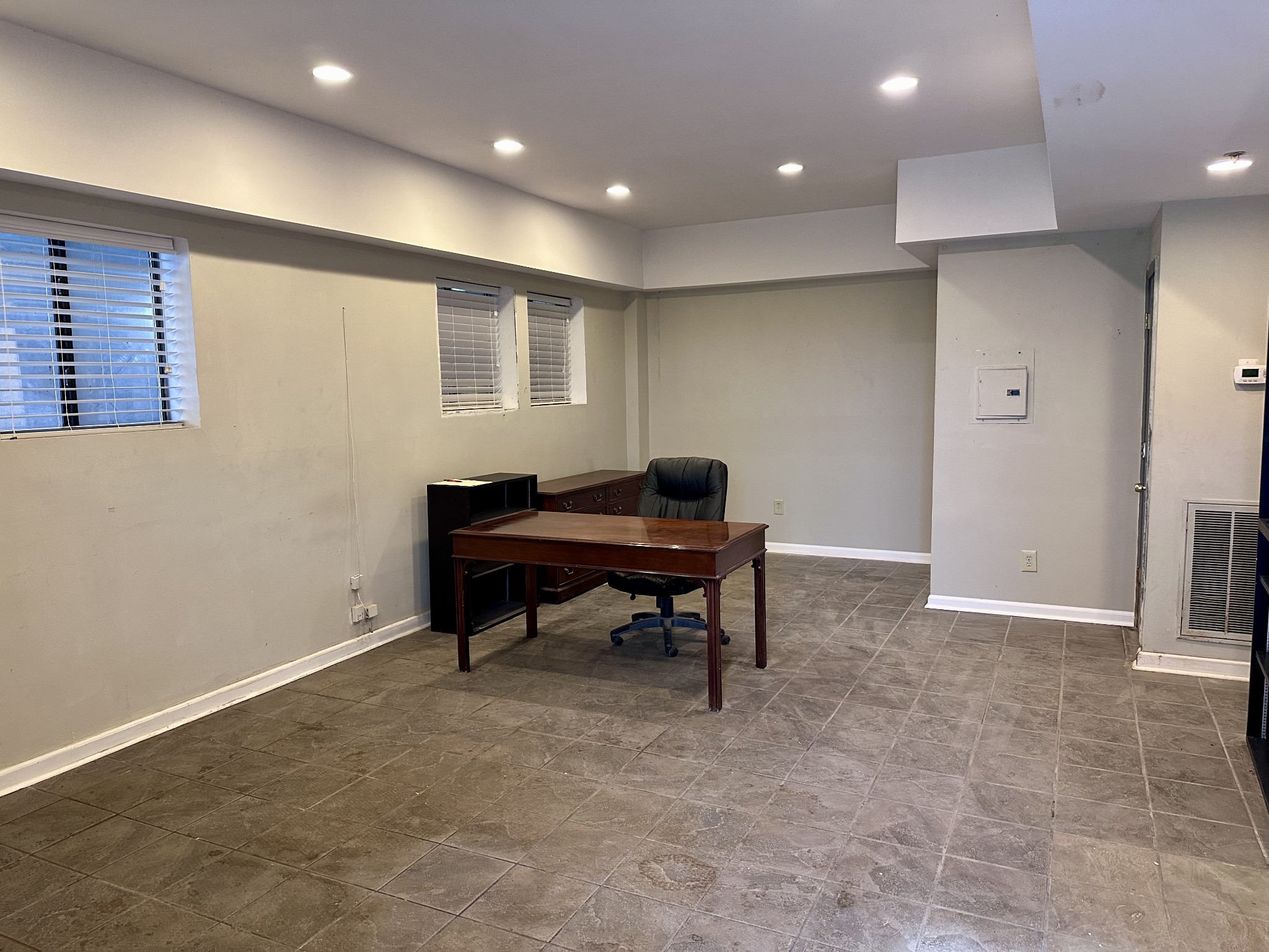 a view of a big room with windows and furniture