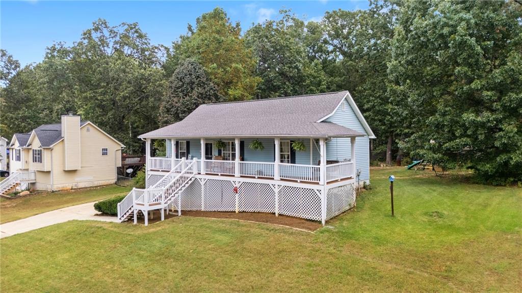 an aerial view of a house with a yard patio and deck