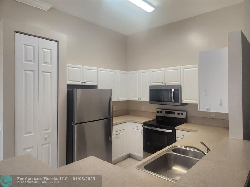 a kitchen with a refrigerator stove and microwave