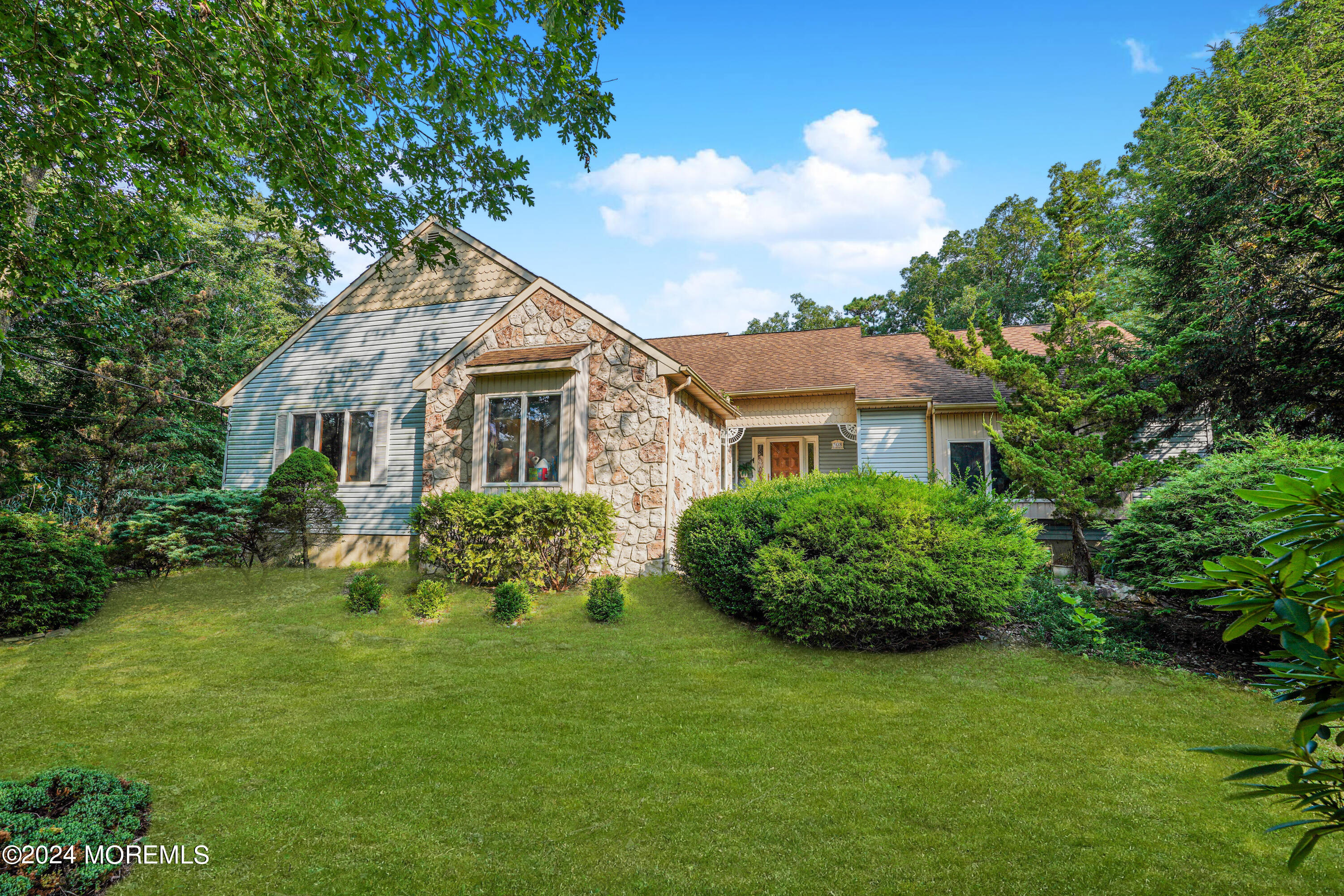 a front view of a house with garden