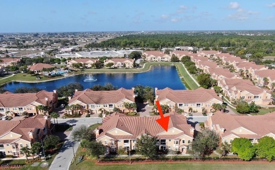 an aerial view of lake and residential houses with outdoor space