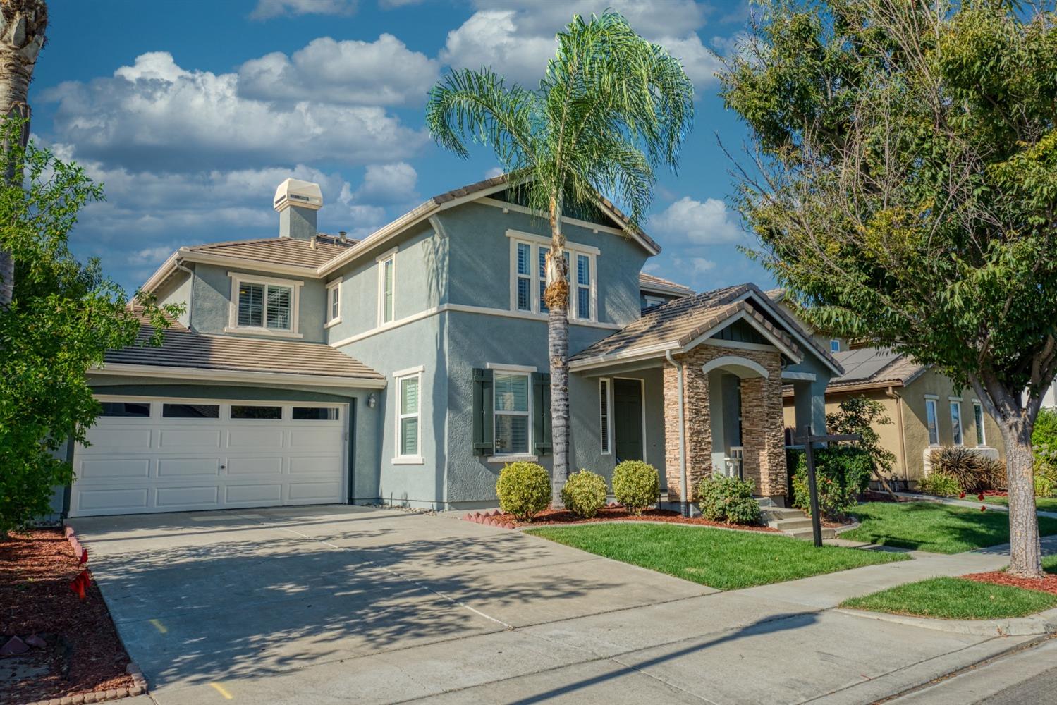 a front view of a house with a garden