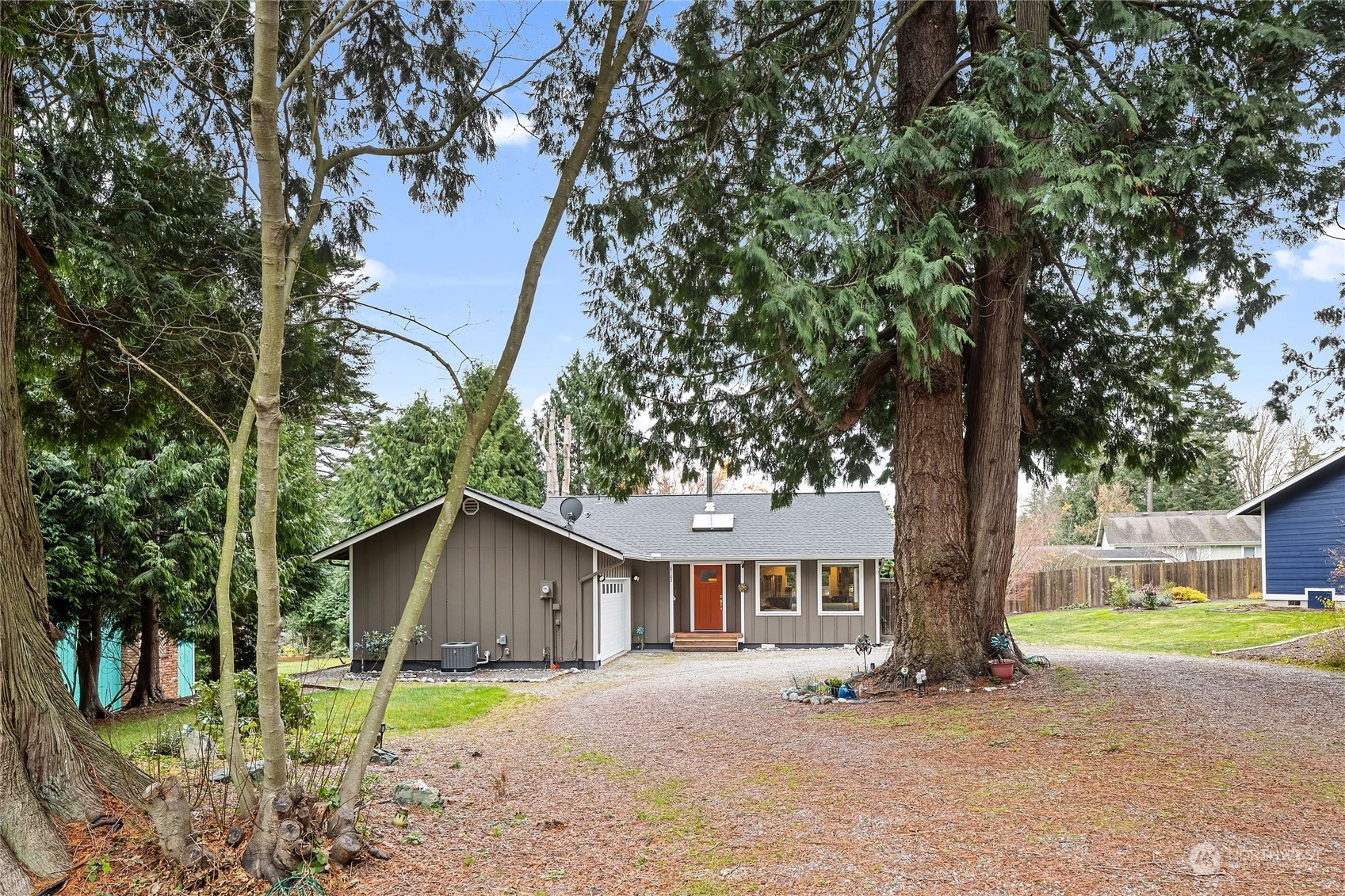 a wooden bench sitting in front of a house