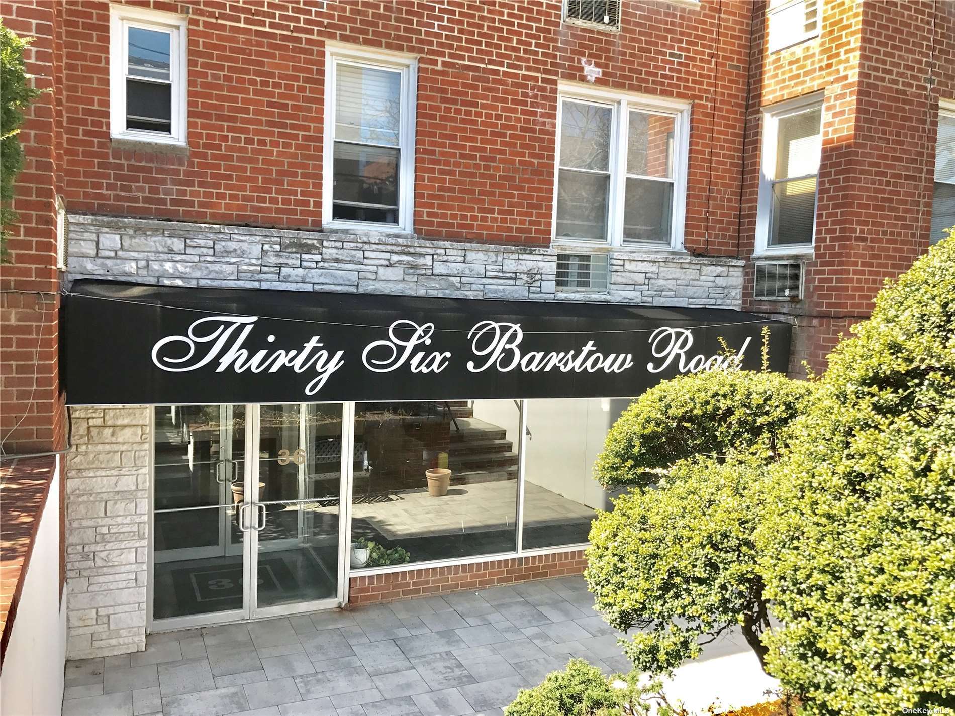 a view of a brick building with a window and a door