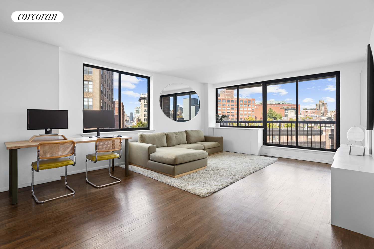 a living room with furniture wooden floor and a flat screen tv