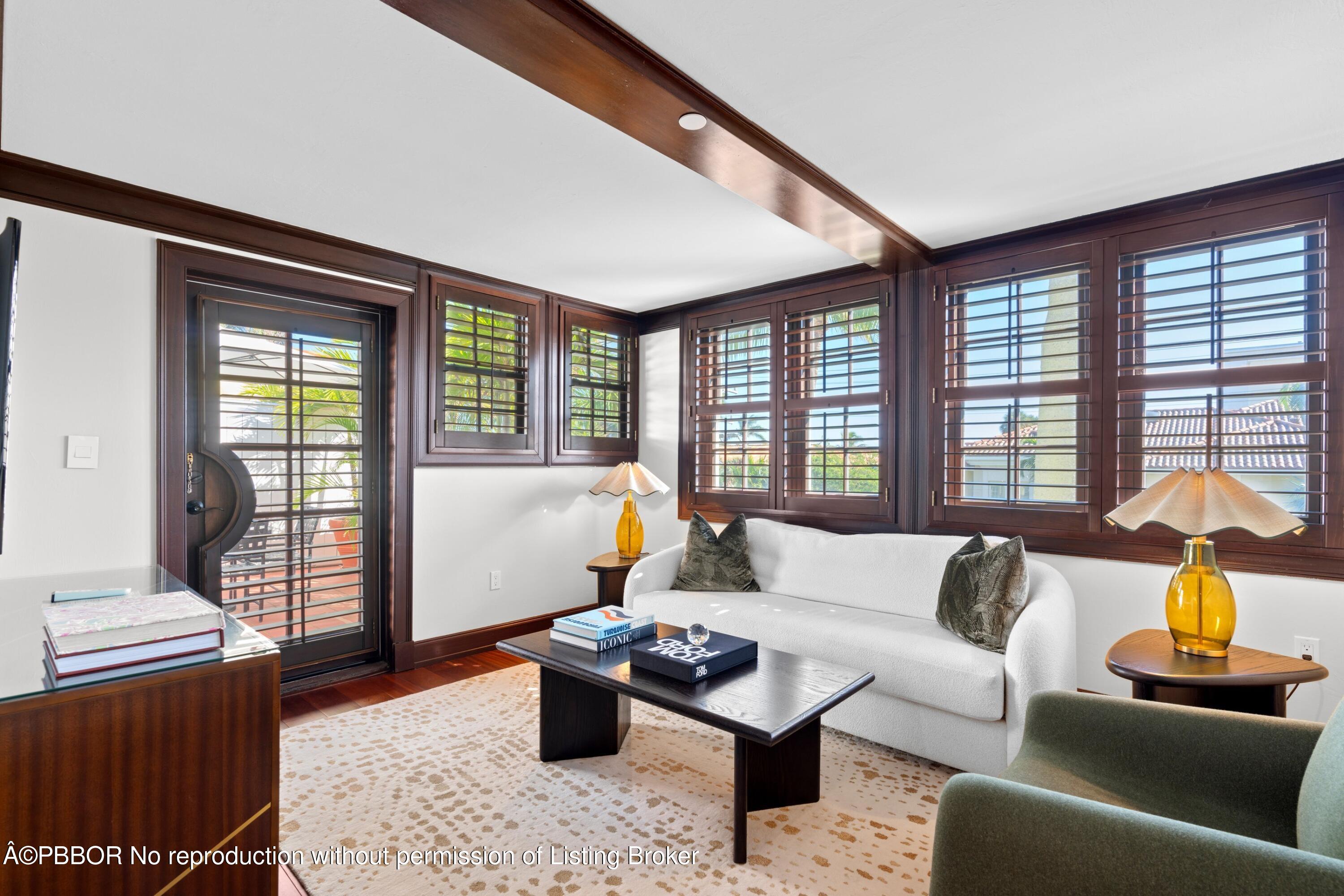 a living room with furniture and a floor to ceiling window