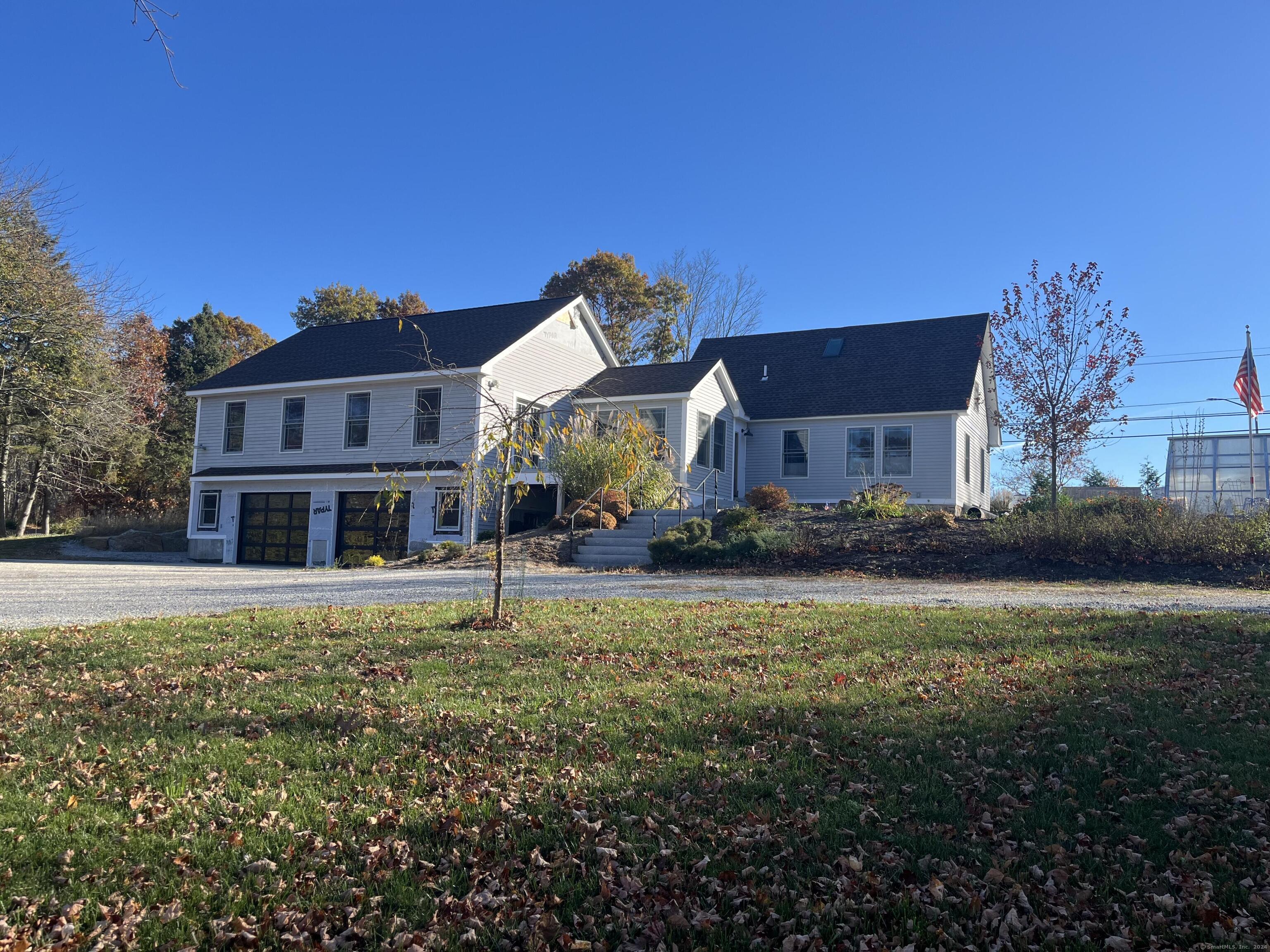 a front view of a house with a garden