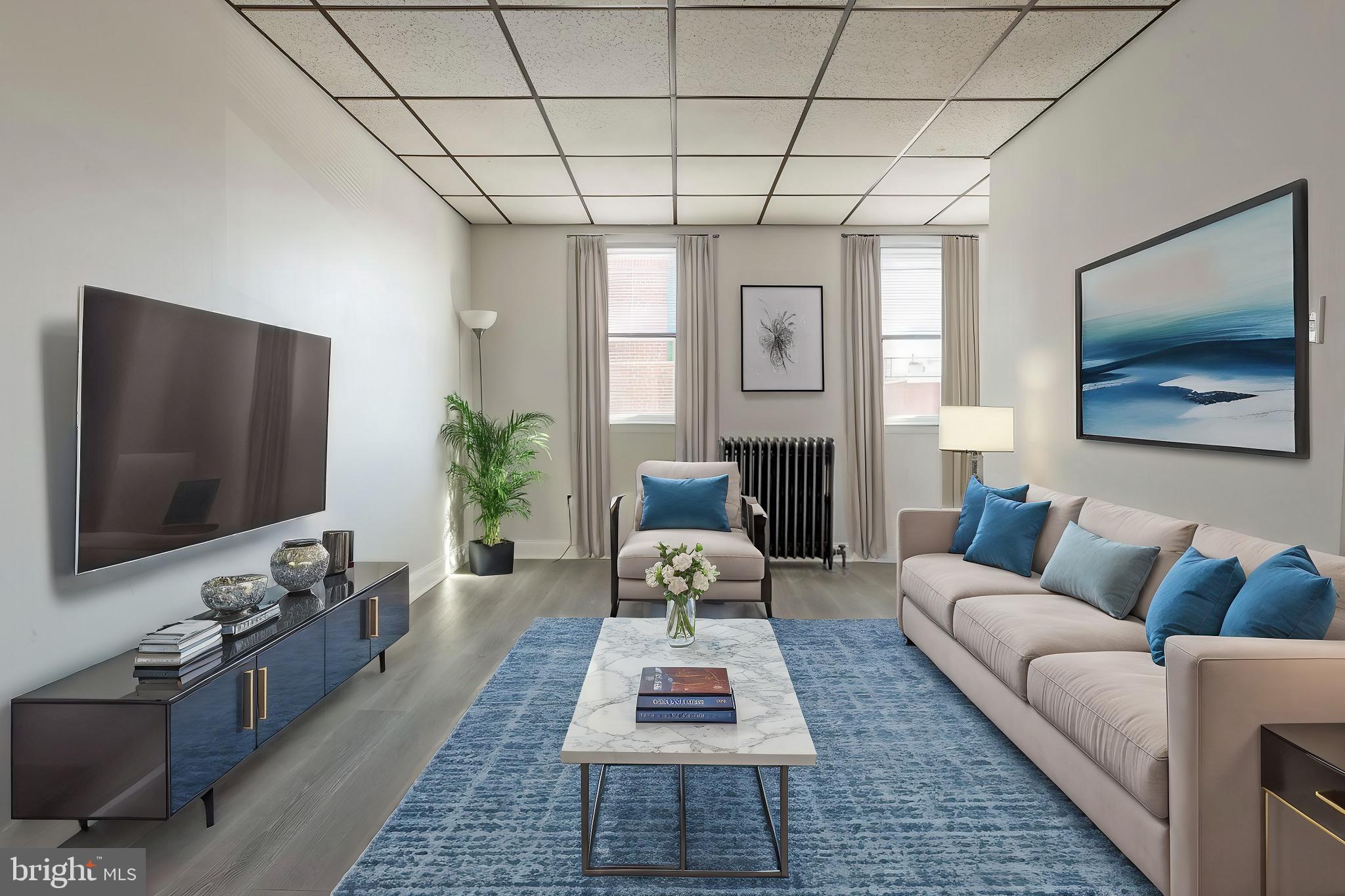 a living room with furniture and a flat screen tv