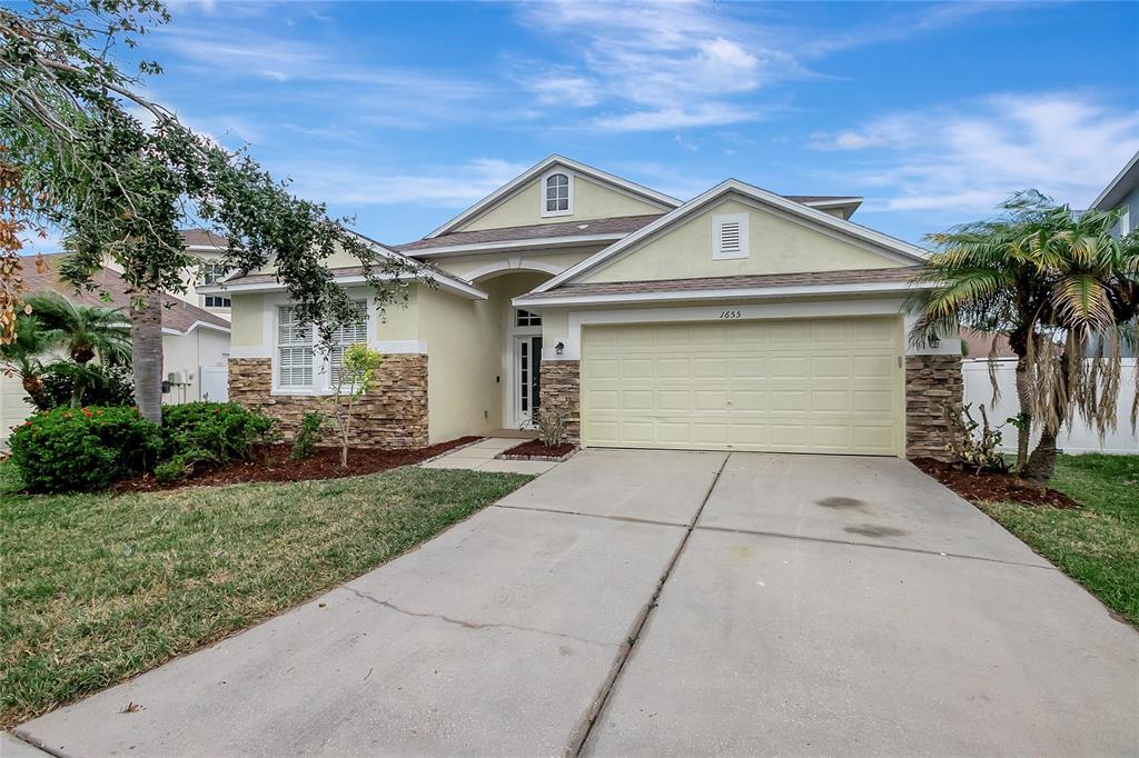 a front view of a house with garage