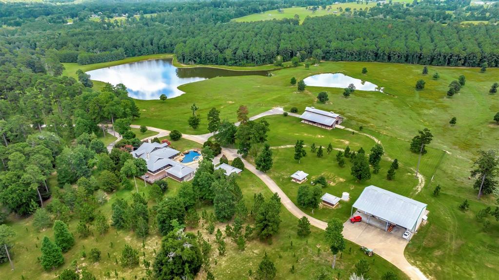 an aerial view of a house with a yard basket ball court and outdoor seating