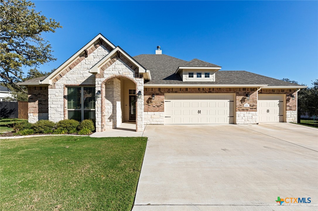 a front view of a house with a yard and garage