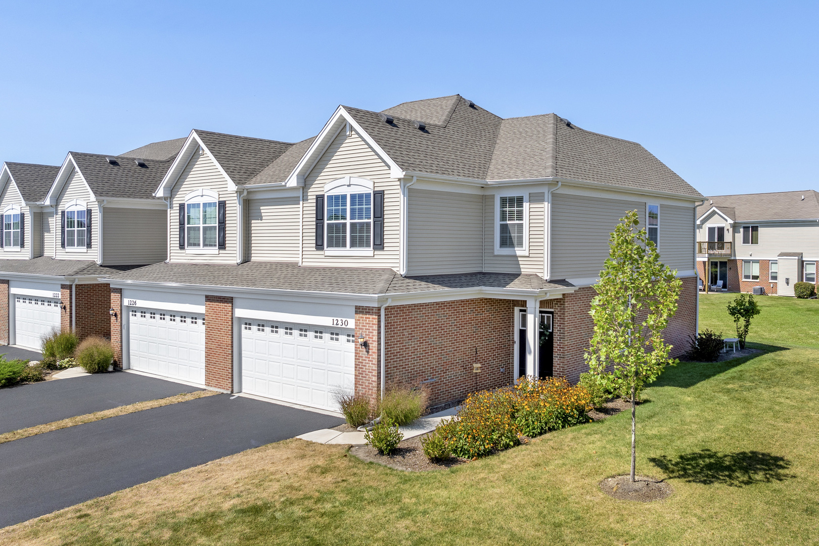 a front view of a house with a yard and garage