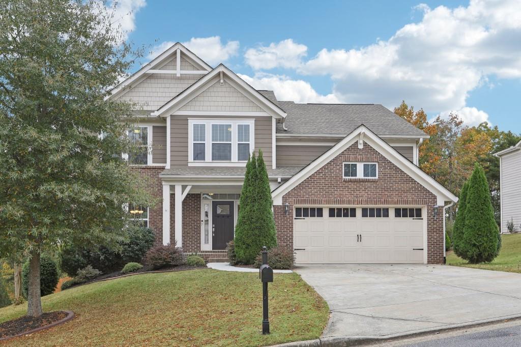 a front view of a house with a yard and garage