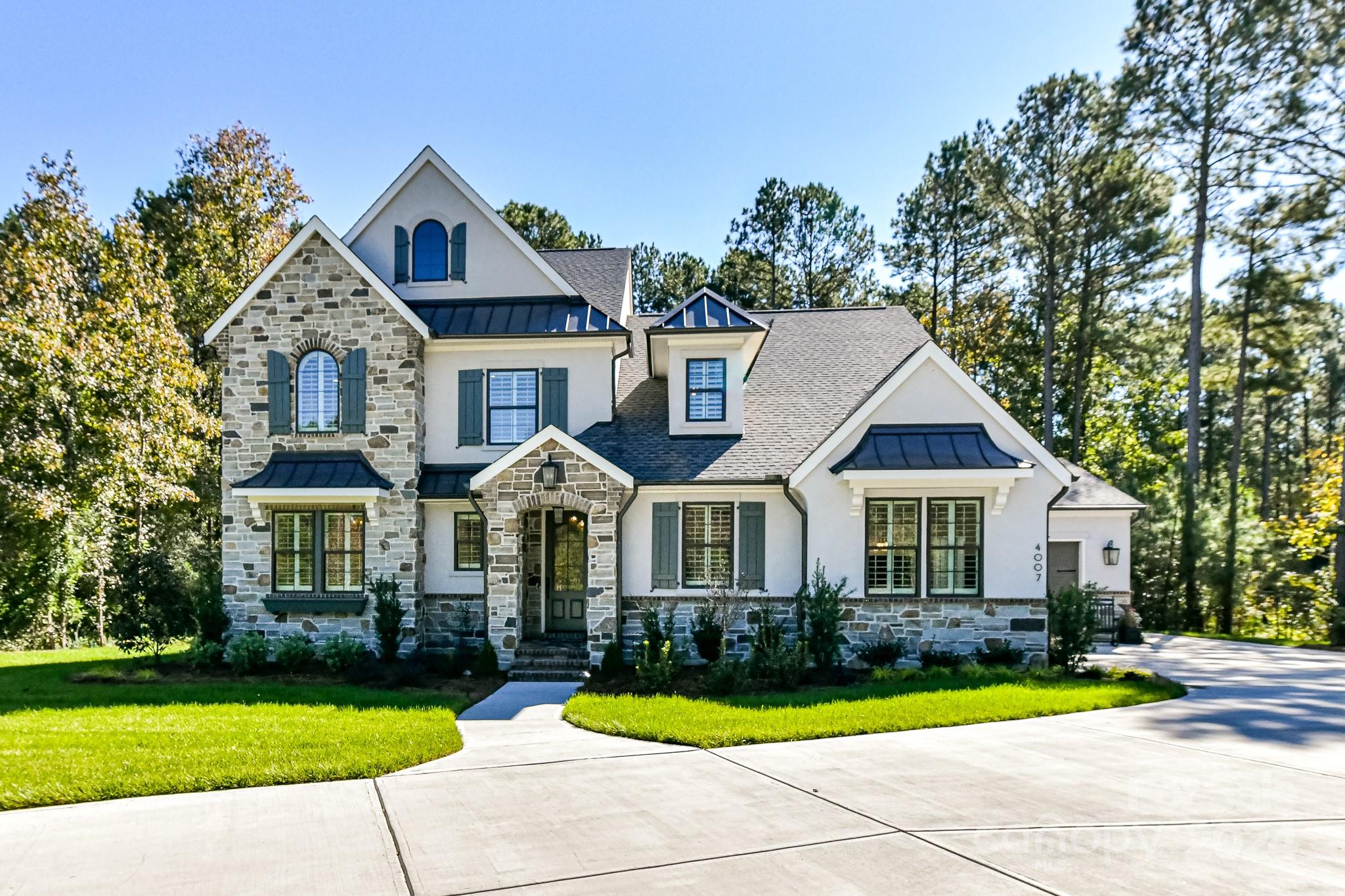 a front view of a house with swimming pool and porch