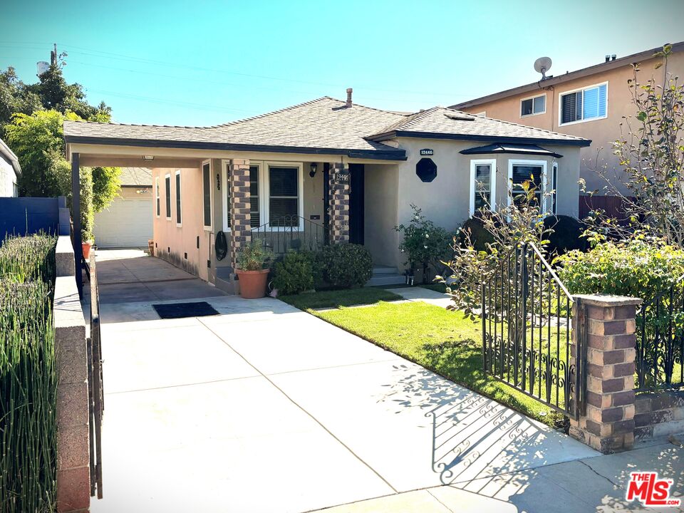 a front view of house with yard outdoor seating and barbeque oven