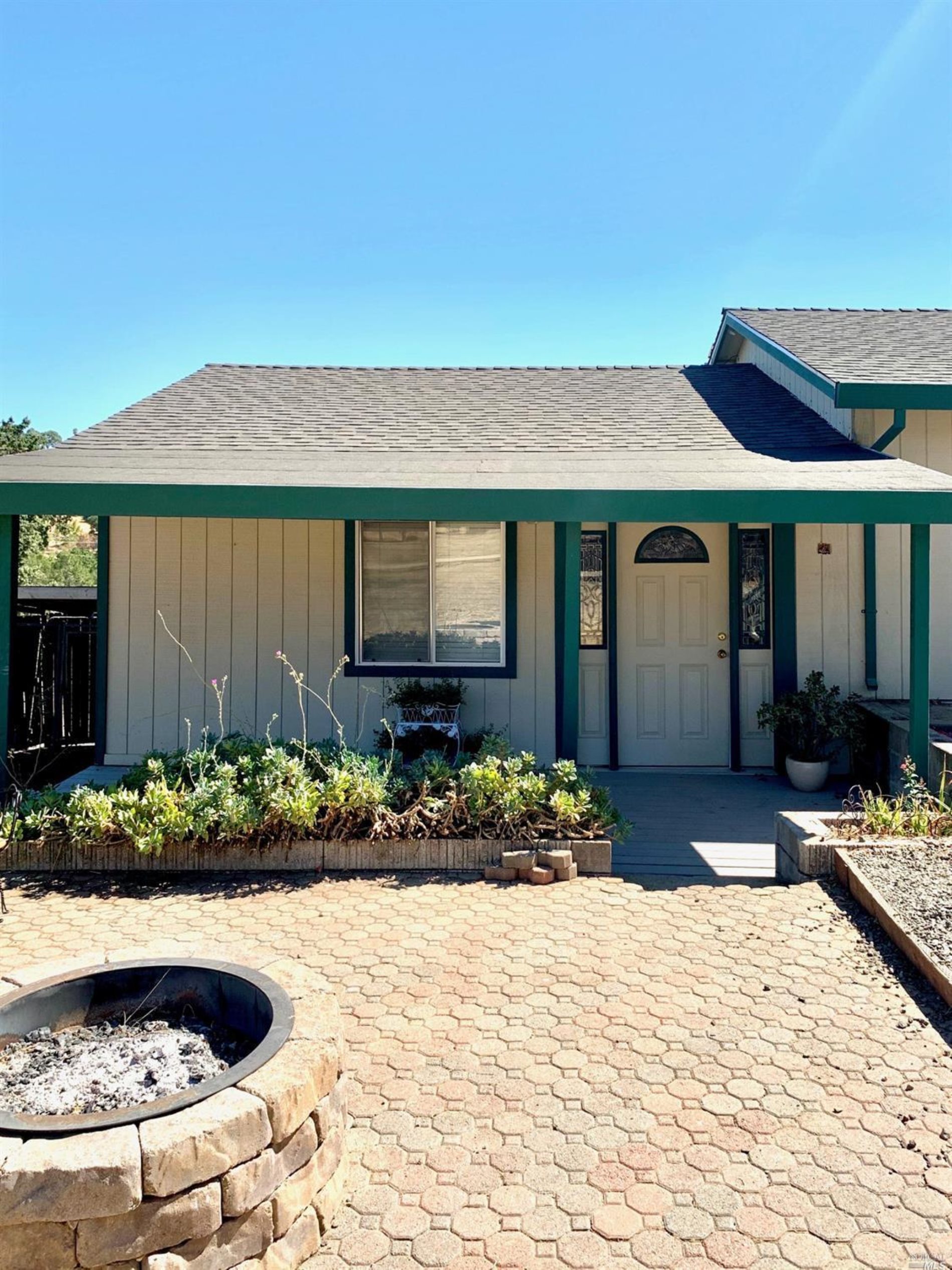 a view of a house with a yard and sitting area