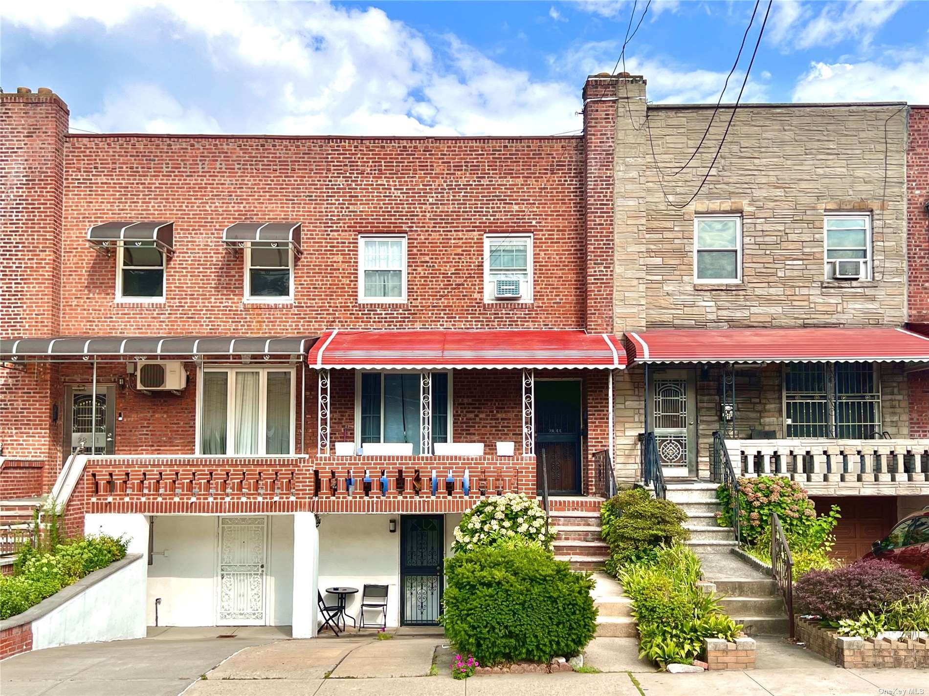 a front view of a residential apartment building with a yard